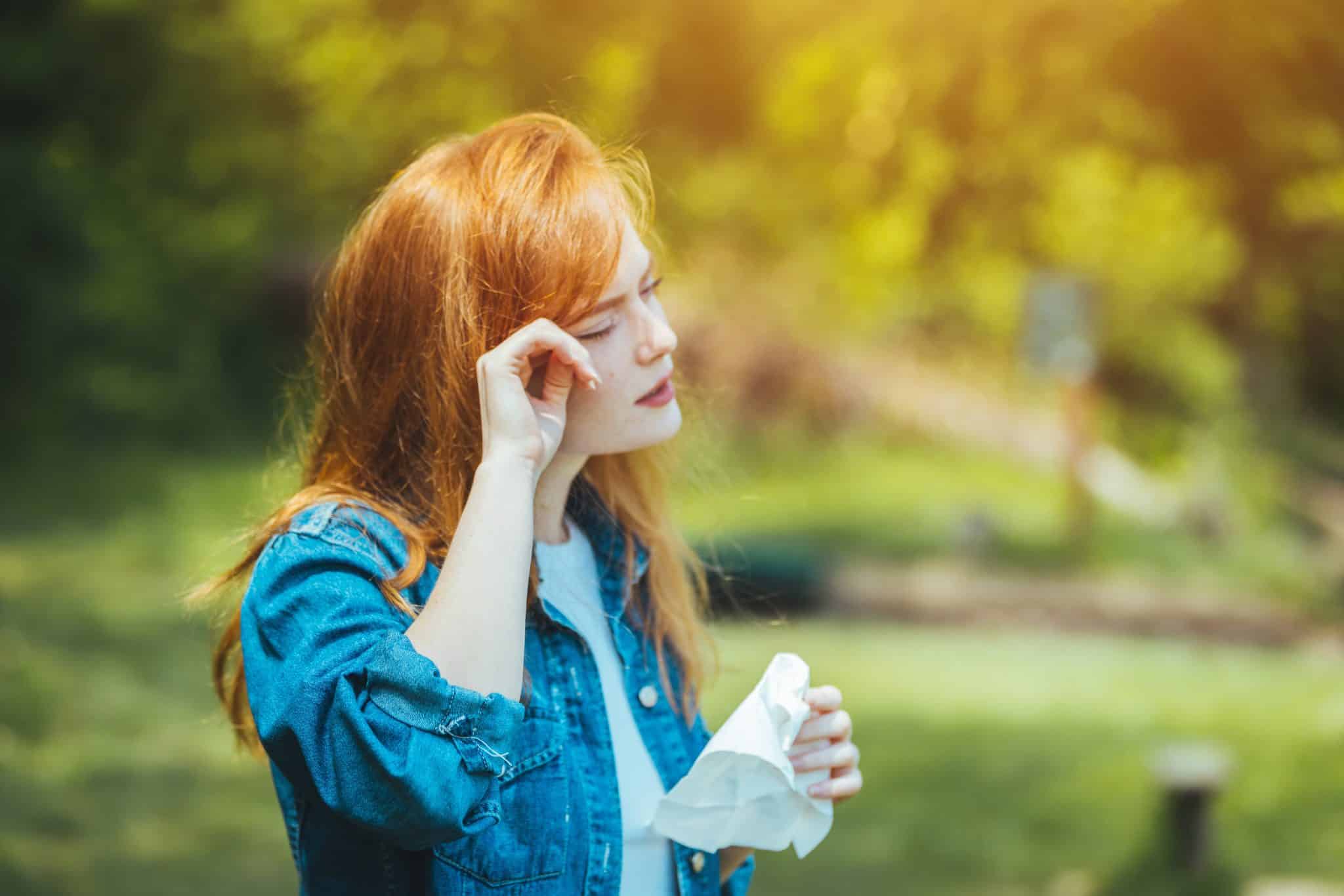young,woman,with,pollen,and,grass,allergies.,flowering,trees,in