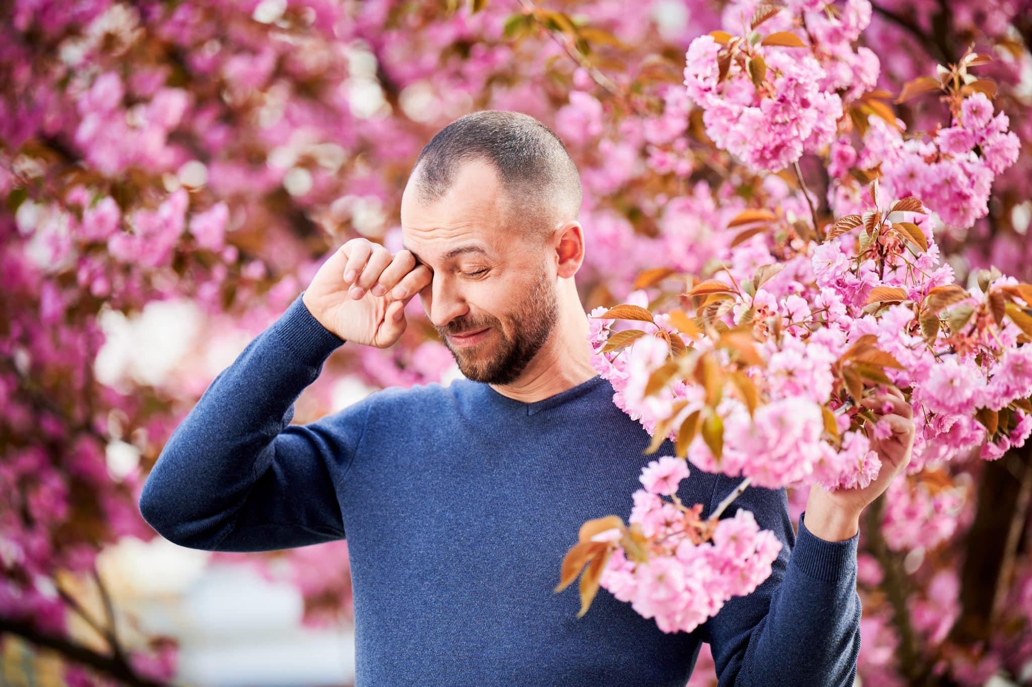 man,allergic,suffering,from,seasonal,allergy,at,spring,in,blossoming