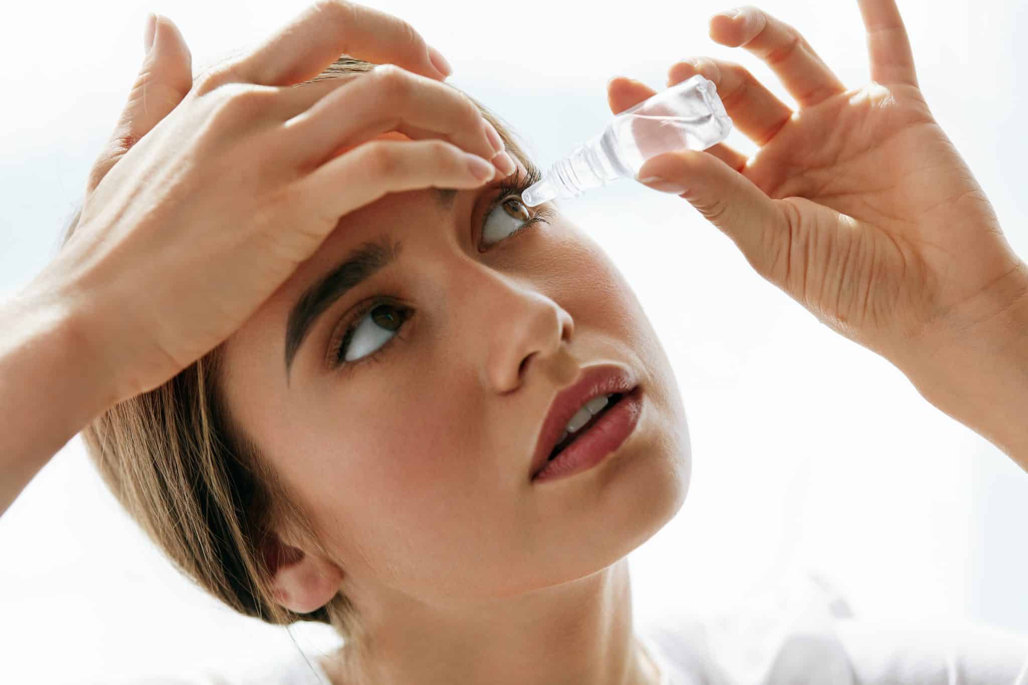 vision,and,ophthalmology,medicine.,closeup,of,beautiful,woman,applying,eyedrops