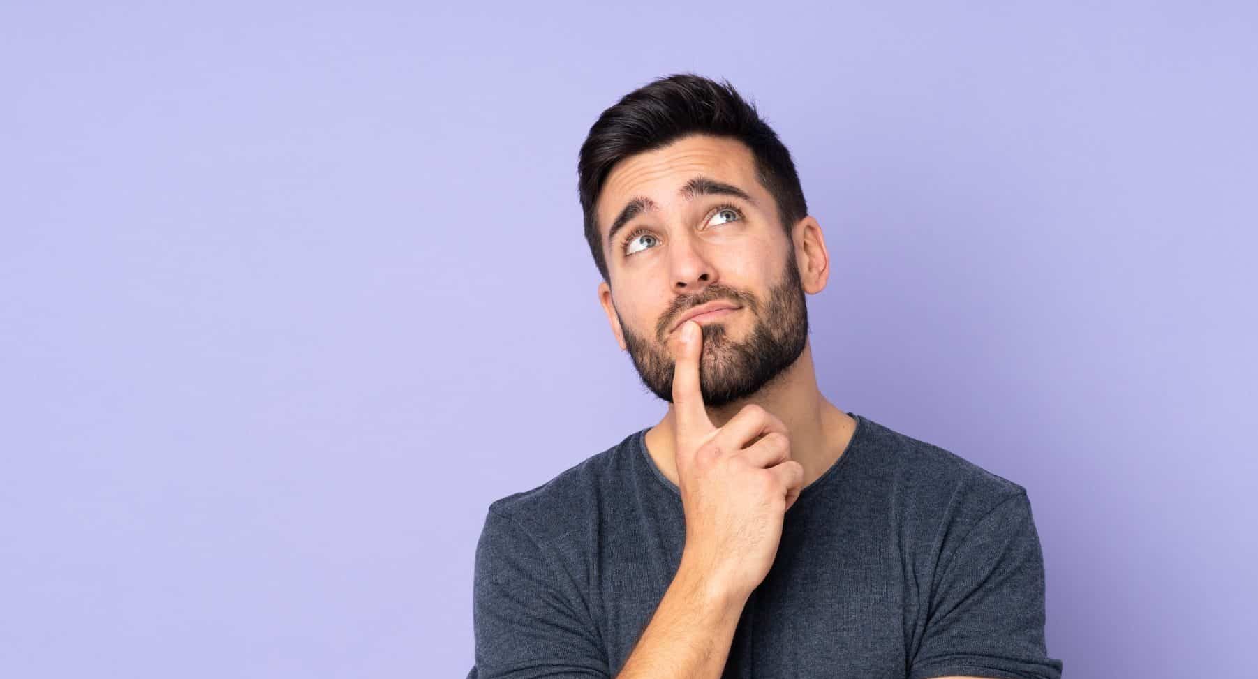 caucasian,handsome,man,having,doubts,while,looking,up,over,isolated